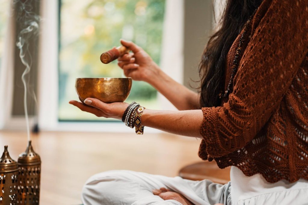 Woman preparing to meditate with incense 