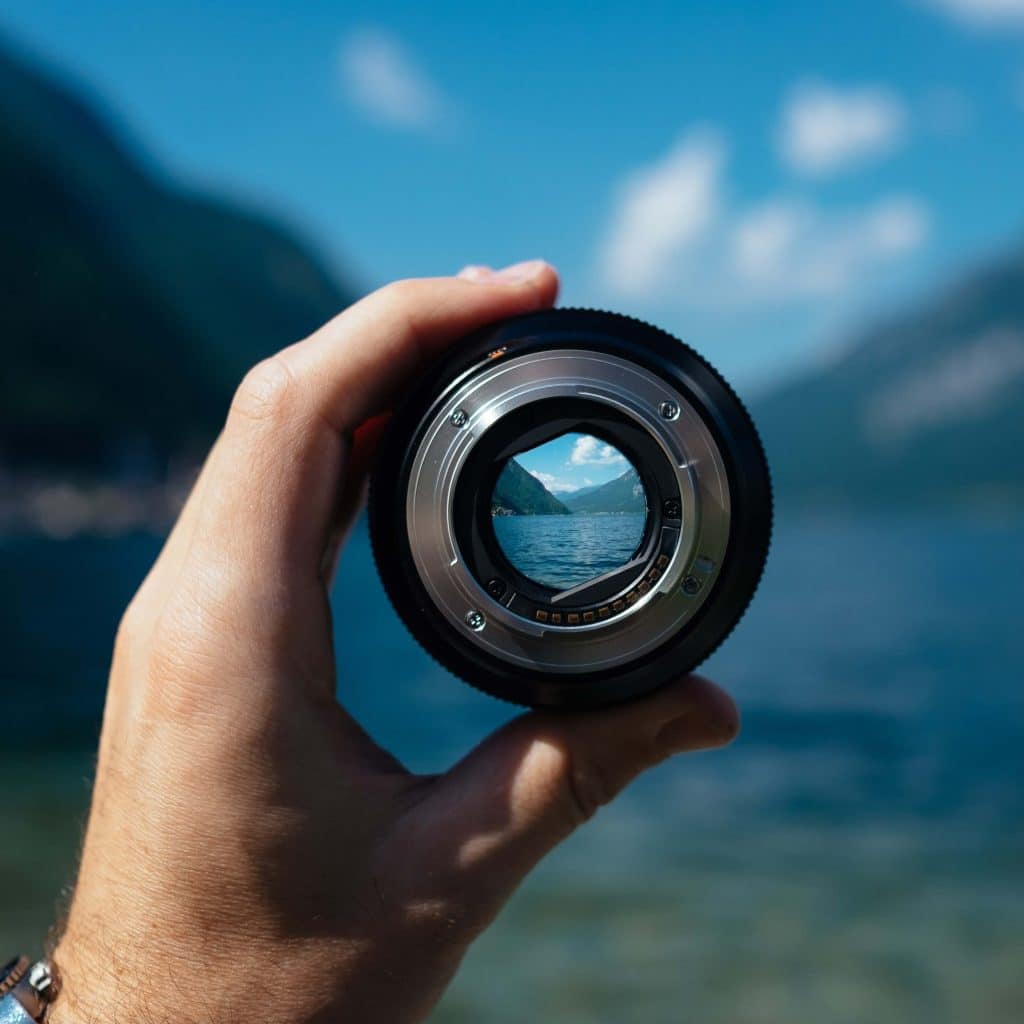 person holding microscope outside